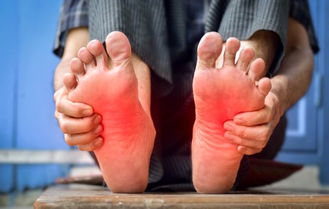 Tingling and burning sensation in feet of Asian old man with diabetes. Foot pain. Sensory neuropathy problems. Foot nerves problems. Plantar fasciitis.