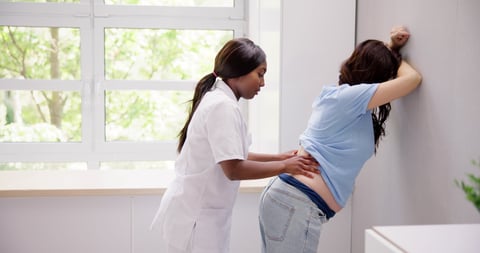 Pregnant Woman And Chiropractor. Osteopathy Doctor Office