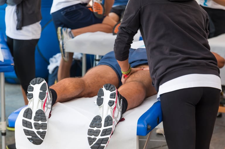 Athletes relaxation massage before sport event, marathon muscles massage